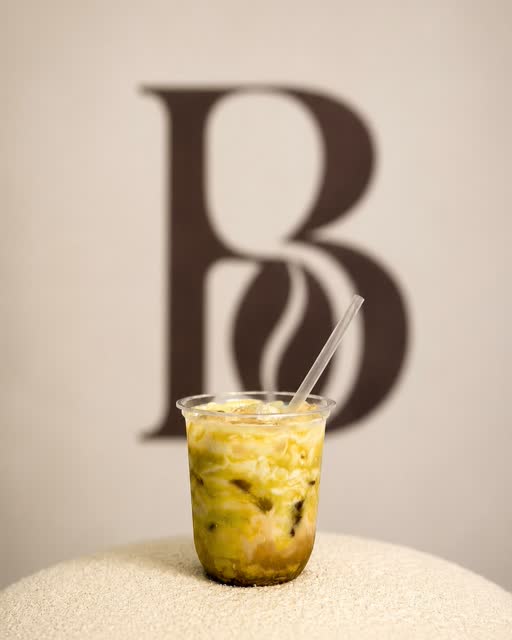 Iced matcha in front of the Barista Bhai monogram