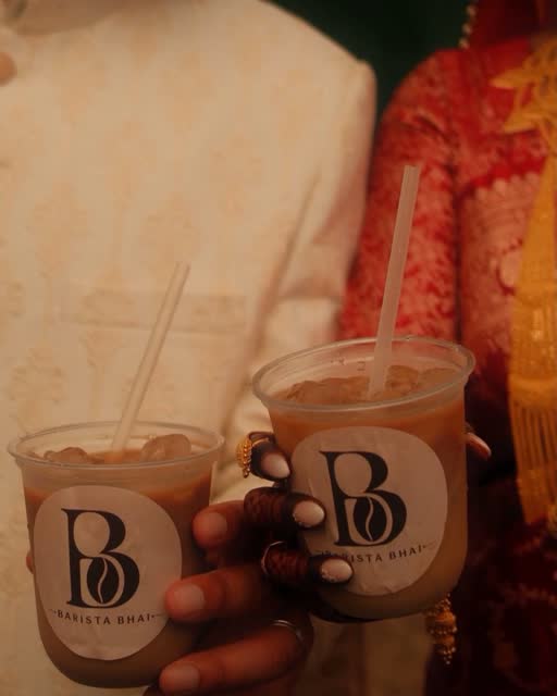 Two branded Barista Bhai cups held close